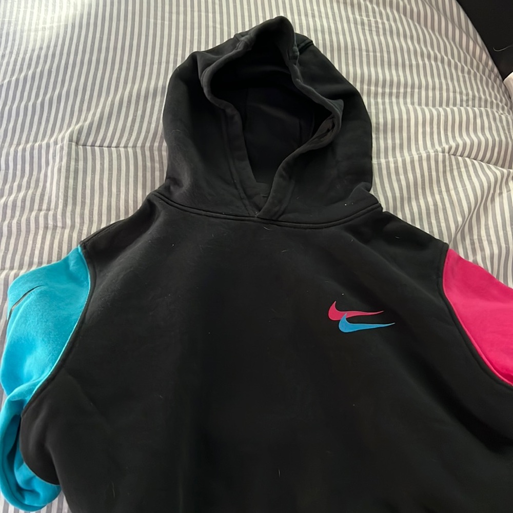 A XL black, pink and blue nike hoodie.